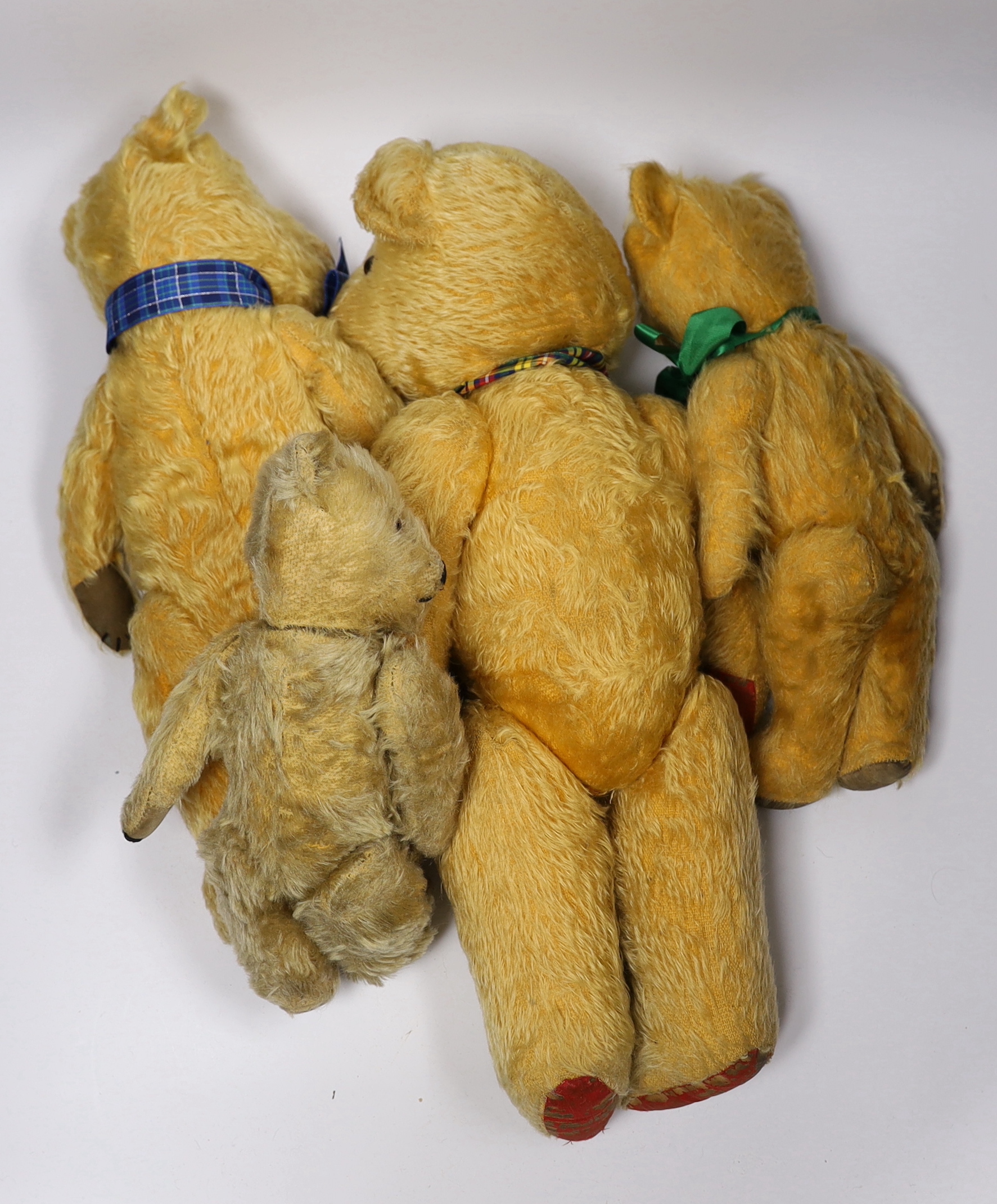 Three Chilterns bears, 1950's, worn, and a large English bear, 42cm (4)